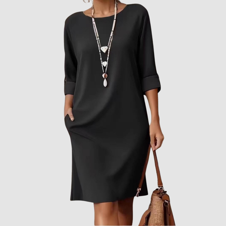 Black crew-neck midi dress with 3/4 sleeves and side slit, loose drape.