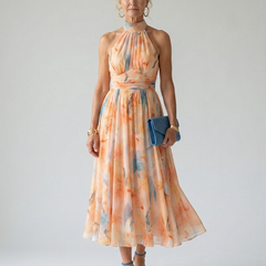 Soft halter midi dress with pastel orange and blue watercolor print, gathered waist