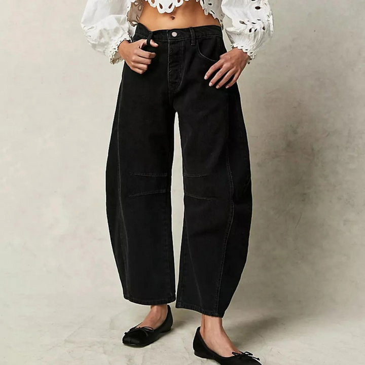 Black wide-leg jeans with belt loops, button closure, and front patch pockets.