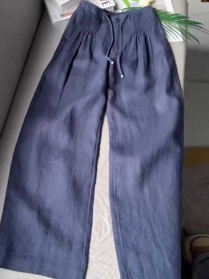 Deep blue wide-leg trousers with elastic waistband, drawstring, and front button