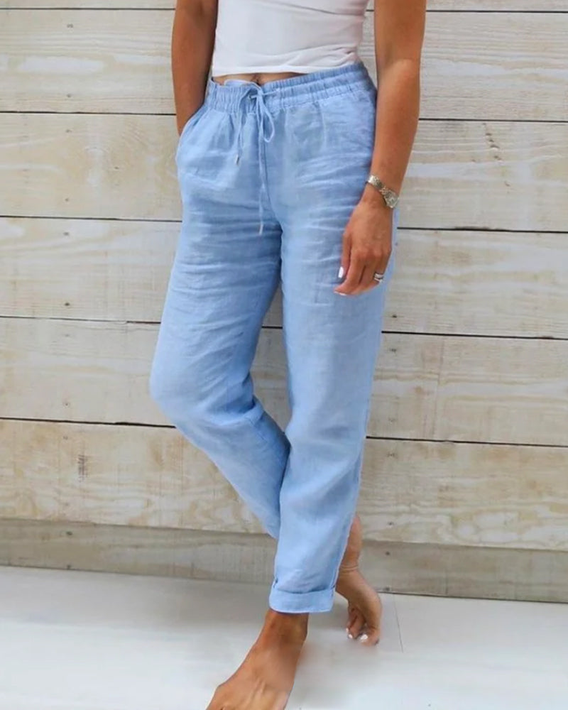 Light blue cotton trousers with drawstring waist and cuffed ankle cuffs