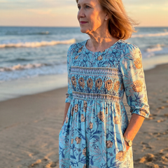 Sky blue floral midi dress with gathered waist, three-quarter sleeves and tiered ruffle skirt