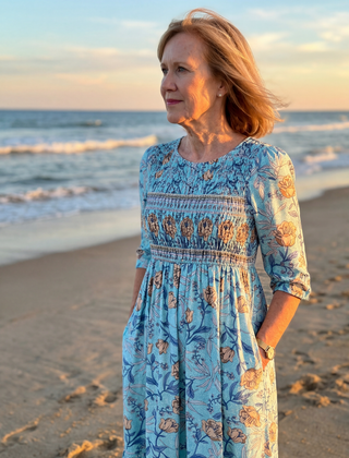 Sky blue floral midi dress with gathered waist, three-quarter sleeves and tiered ruffle skirt