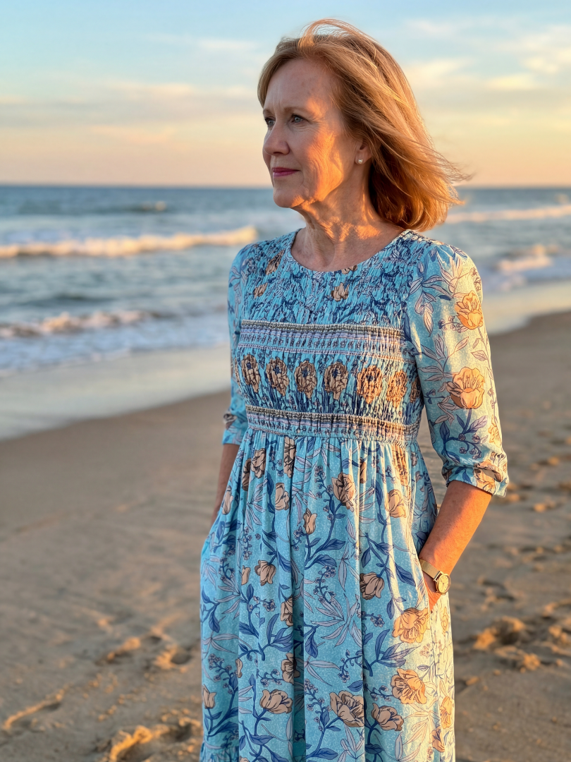 Sky blue floral midi dress with gathered waist, three-quarter sleeves and tiered ruffle skirt