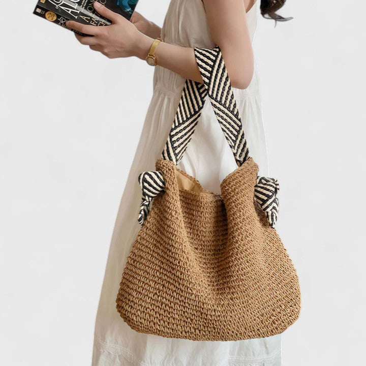 Woven boho tote bag in warm brown with striped fabric handles and side knotted ties