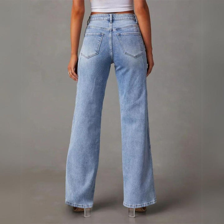 Light blue flared jeans showing back pockets and wide straight-to-flare legs