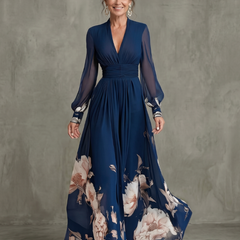 Navy pleated maxi dress with long sheer sleeves and floral hem