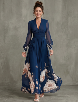 Navy pleated maxi dress with long sheer sleeves and floral hem