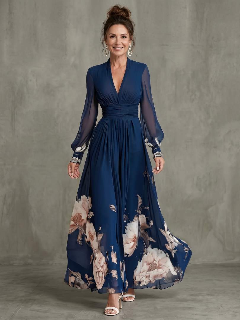 Navy pleated maxi dress with long sheer sleeves and floral hem