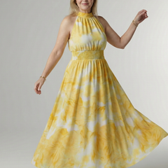 Yellow halter midi dress with gathered bodice and full gathered skirt, tie-dye pattern