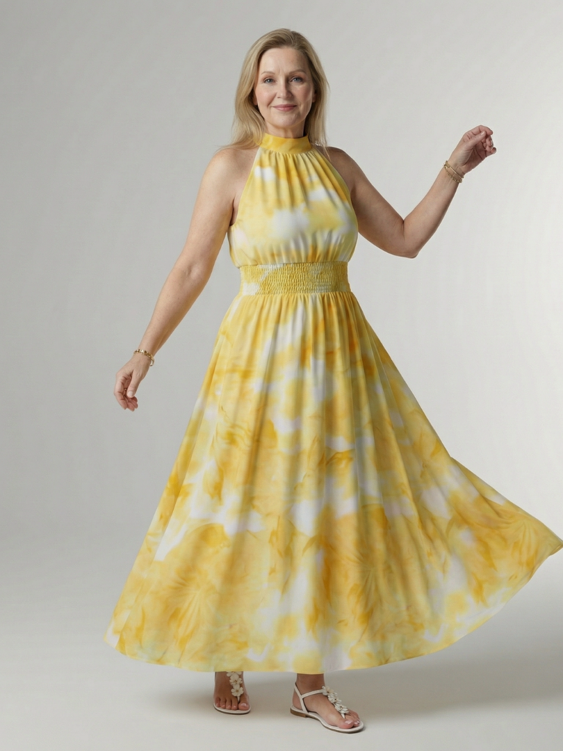 Yellow halter midi dress with gathered bodice and full gathered skirt, tie-dye pattern