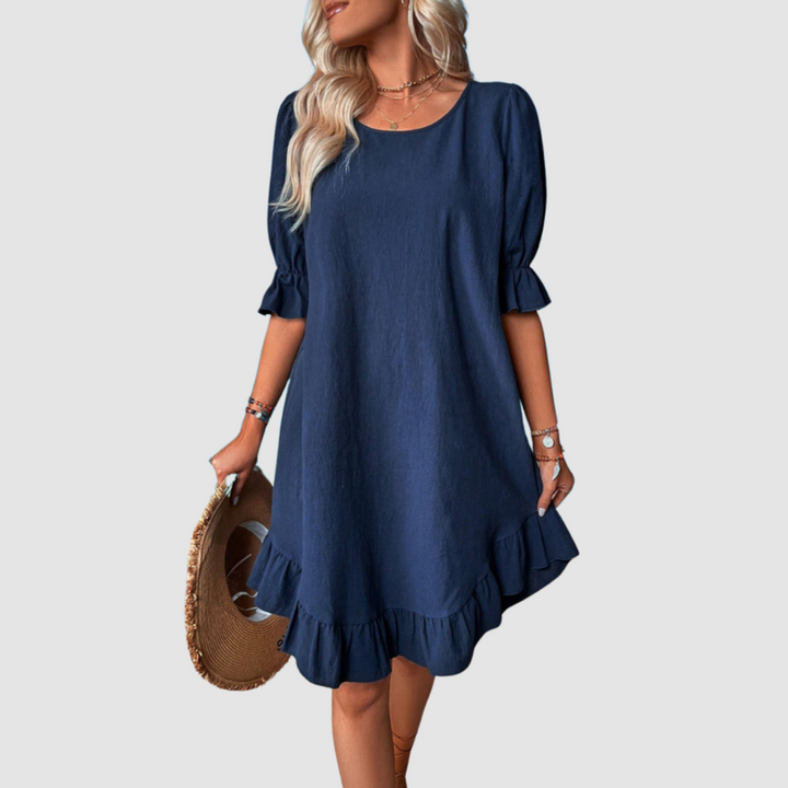 Blue flowy summer dress with half sleeves and gathered ruffle hem.