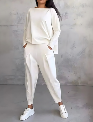 White two-piece lounge set with long-sleeve sweatshirt and tapered jogger pants
