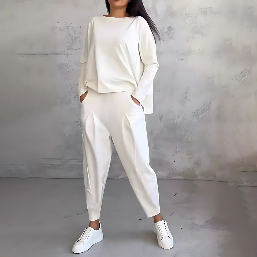 White two-piece lounge set with long-sleeve sweatshirt and tapered jogger pants