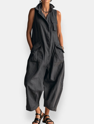 Black oversized sleeveless jumpsuit with open collar and chest patch pockets