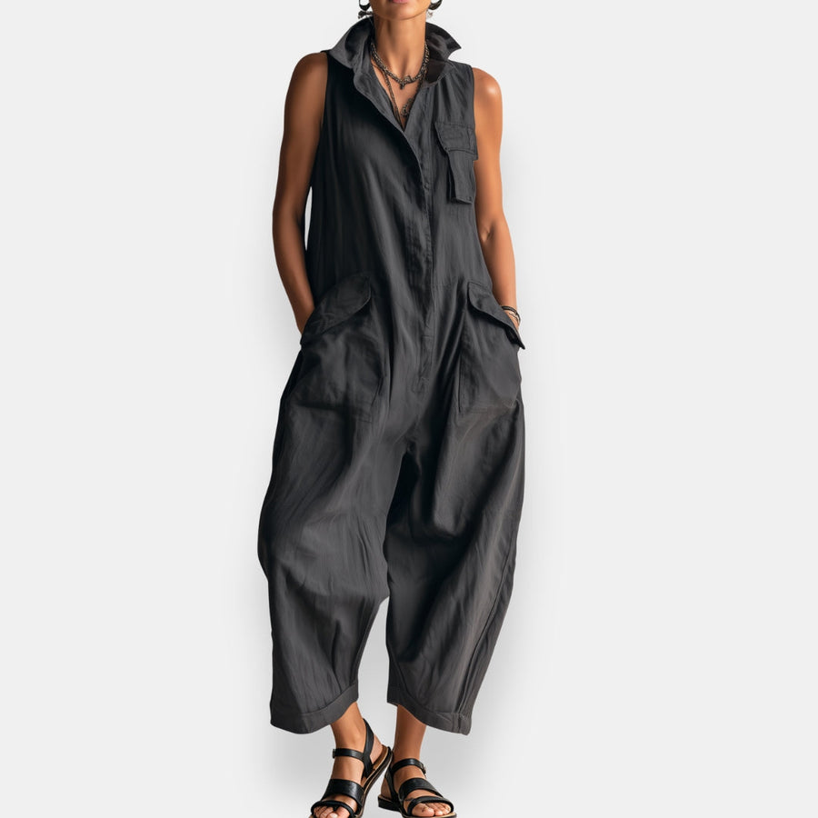 Black oversized sleeveless jumpsuit with open collar and chest patch pockets