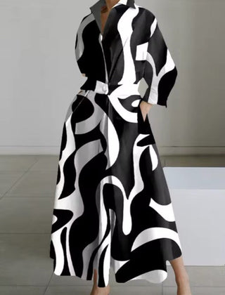 Black shirt dress with abstract white swirl pattern, long sleeves, button front