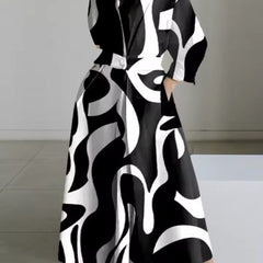 Black and white abstract print shirt dress with collar and long sleeves, belted waist