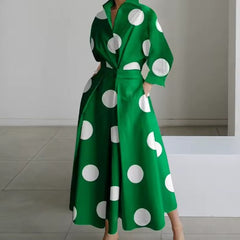 Green shirt dress with large white polka dots, long sleeves, belted waist