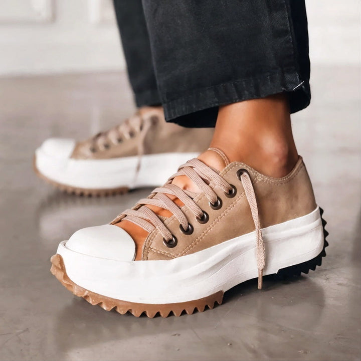 Platform sneakers in tan and white with lace-up eyelets and chunky rubber sole