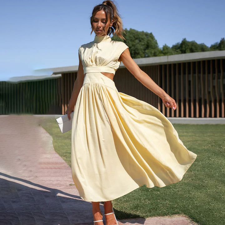 Light yellow sleeveless maxi dress with high neck and gathered waist pleated skirt