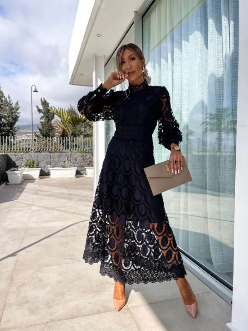Black romantic lace dress with textured floral lace and long puff sleeves, midi hem.