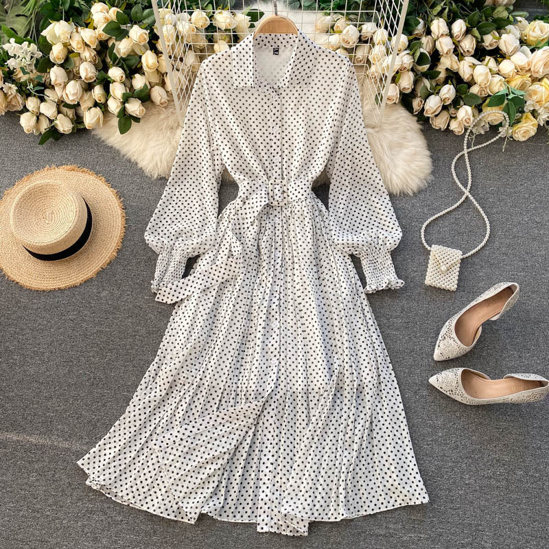 White polka dot chiffon pleated dress with button front, long sleeves, tied waist.