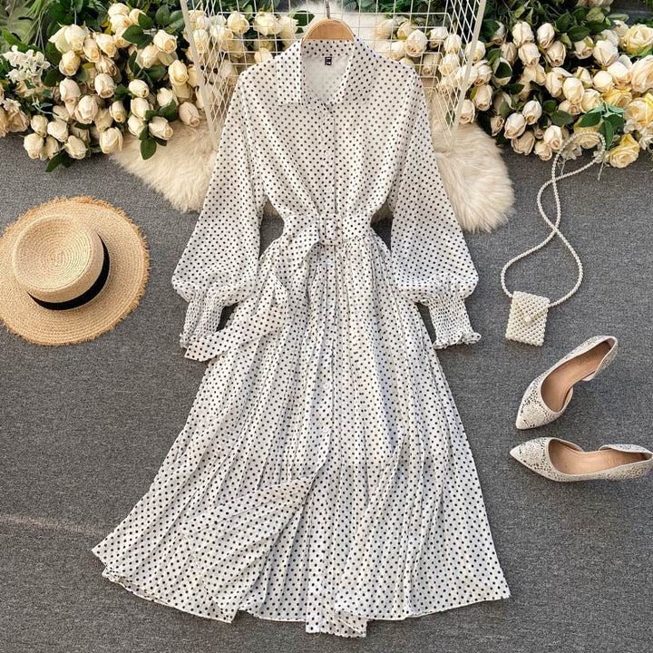 White polka dot chiffon pleated dress with button front, long sleeves, tied waist.