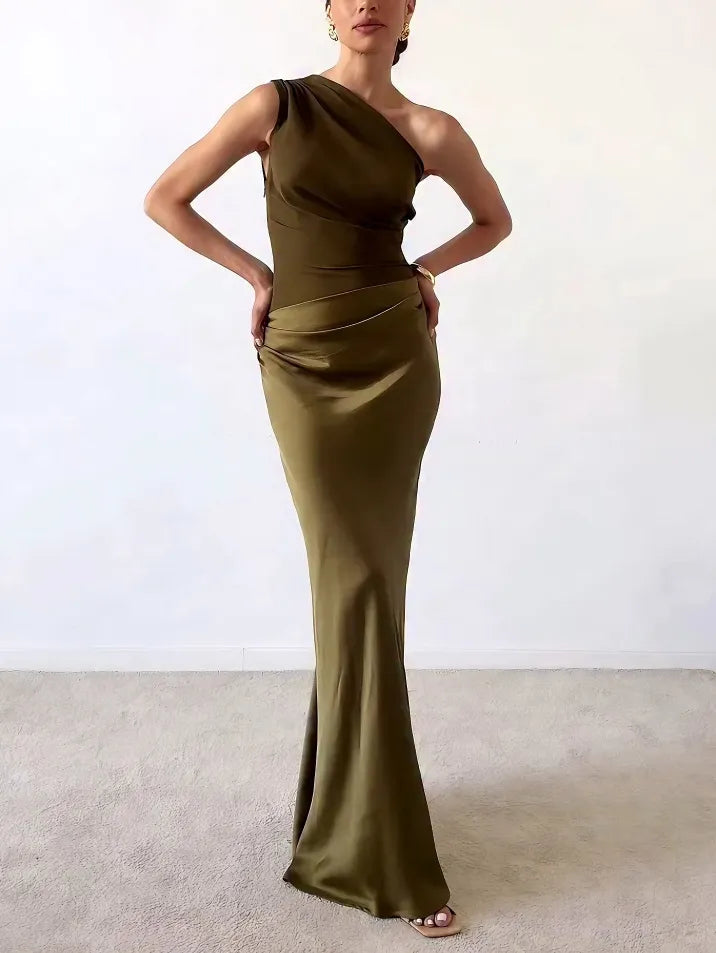 One-shoulder satin maxi dress in dark green with pleated waist and fitted mermaid silhouette.