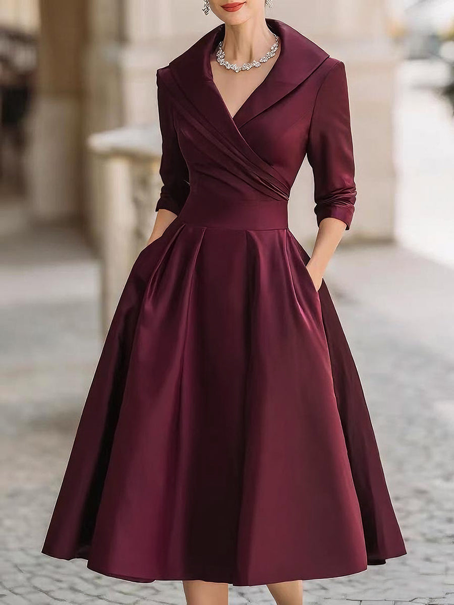 Burgundy midi dress with wrap V-neck, 3/4 sleeves, and flared pleated skirt