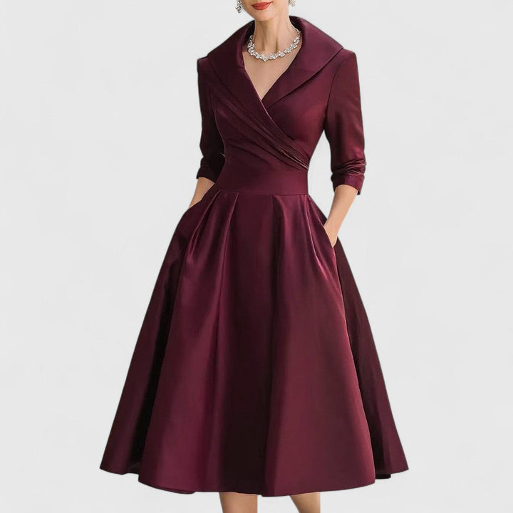 Deep red midi wrap dress with V-neck, 3/4 sleeves, pleated full skirt.
