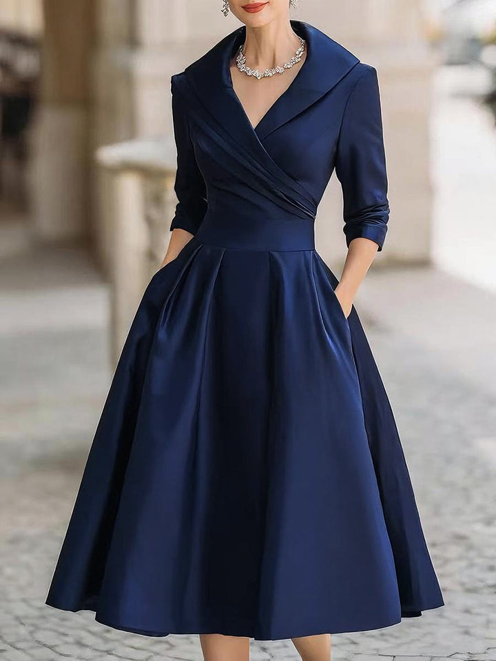 Navy wrap V-neck dress with 3/4 sleeves and flared knee-length skirt