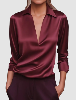 Burgundy satin blouse with pointed collar, deep V-neck, long sleeves, button cuffs.