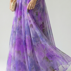 Close-up of purple pleated maxi skirt with airy tulle overlay and wrap waist detail, side view.