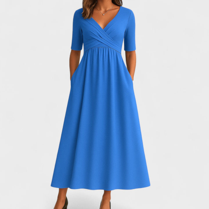 Light blue wrap-style midi dress with V-neck, short sleeves, and gathered waist