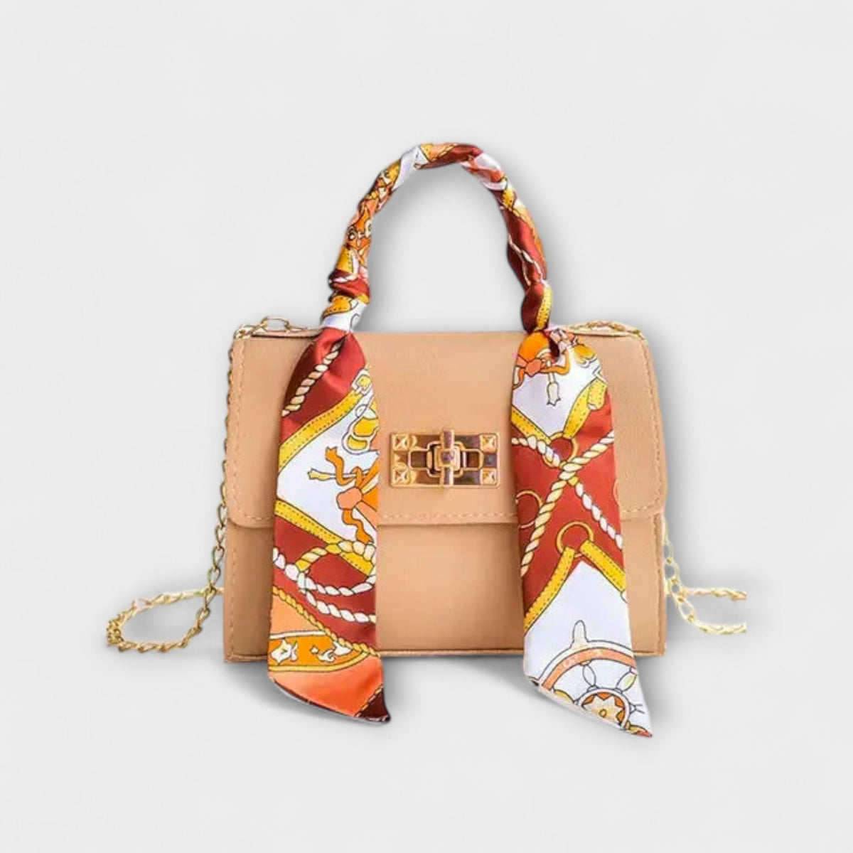 Beige handbag with gold clasp, chain strap, and red patterned scarf handle