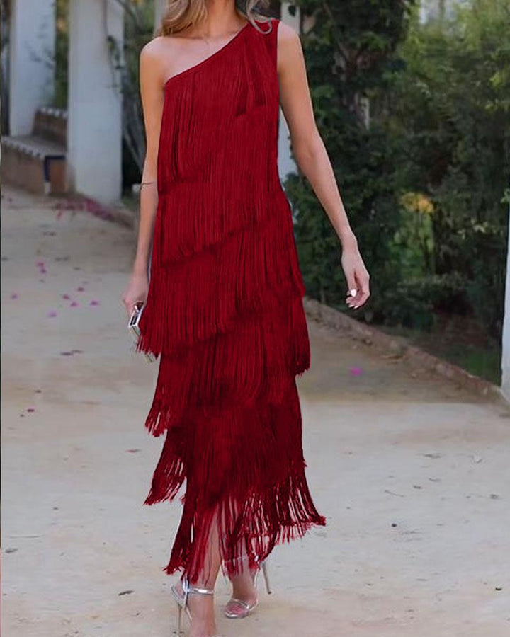 Red one-shoulder fringe dress with layered tassel tiers and fitted silhouette
