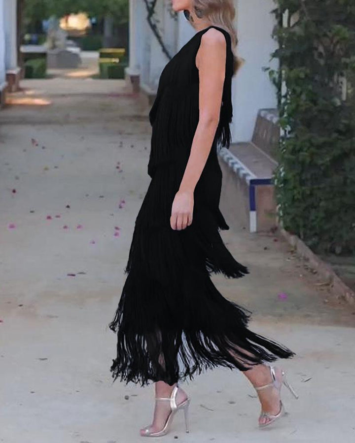 Black one-shoulder fringe dress with layered tassel tiers and fitted silhouette