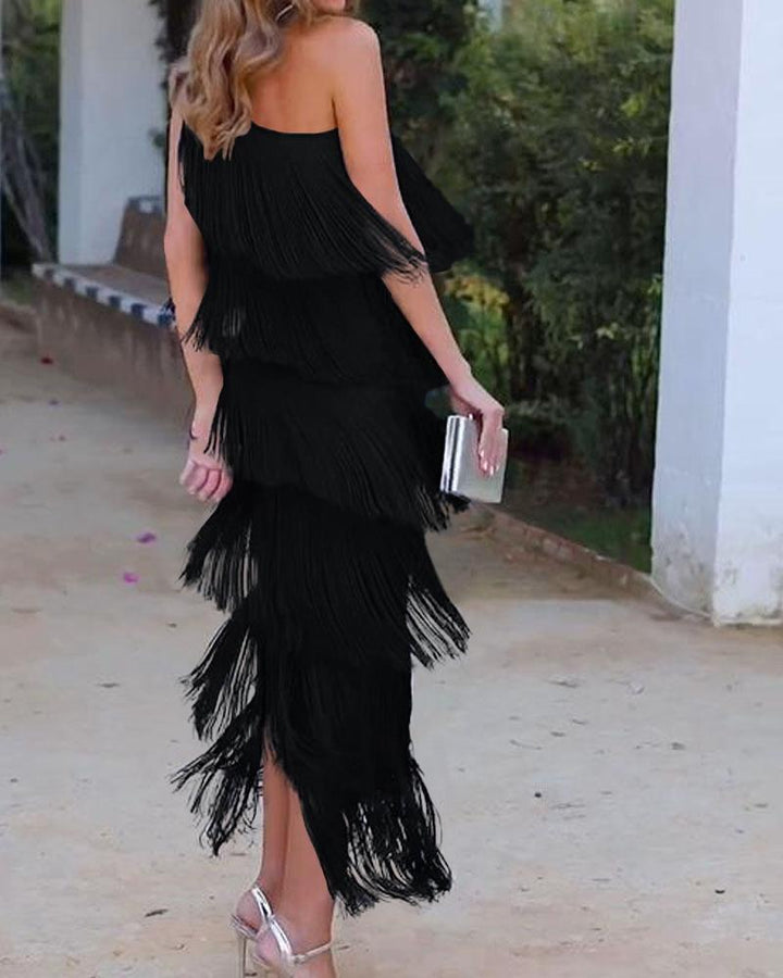 Black one-shoulder fringe dress with layered tassel tiers and fitted silhouette