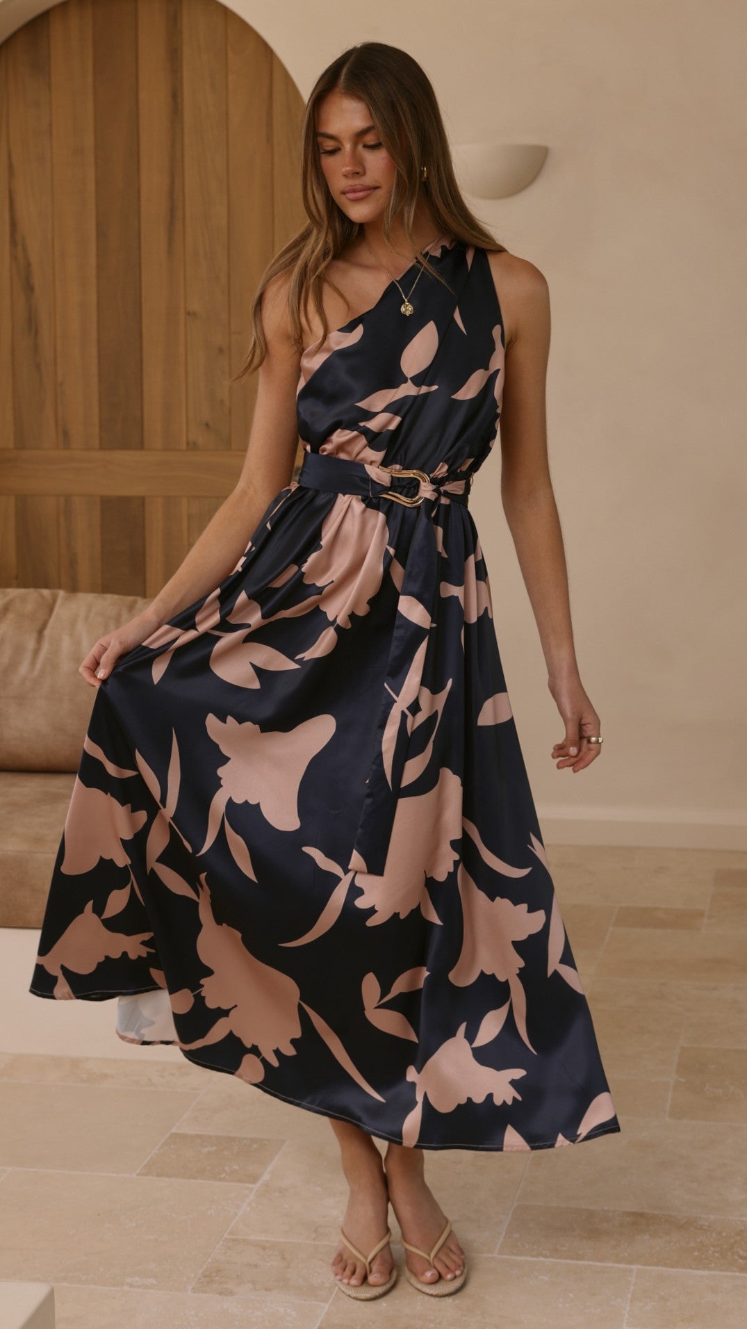 Navy maxi dress with pink floral print, draped skirt, belted waist, sleeveless.