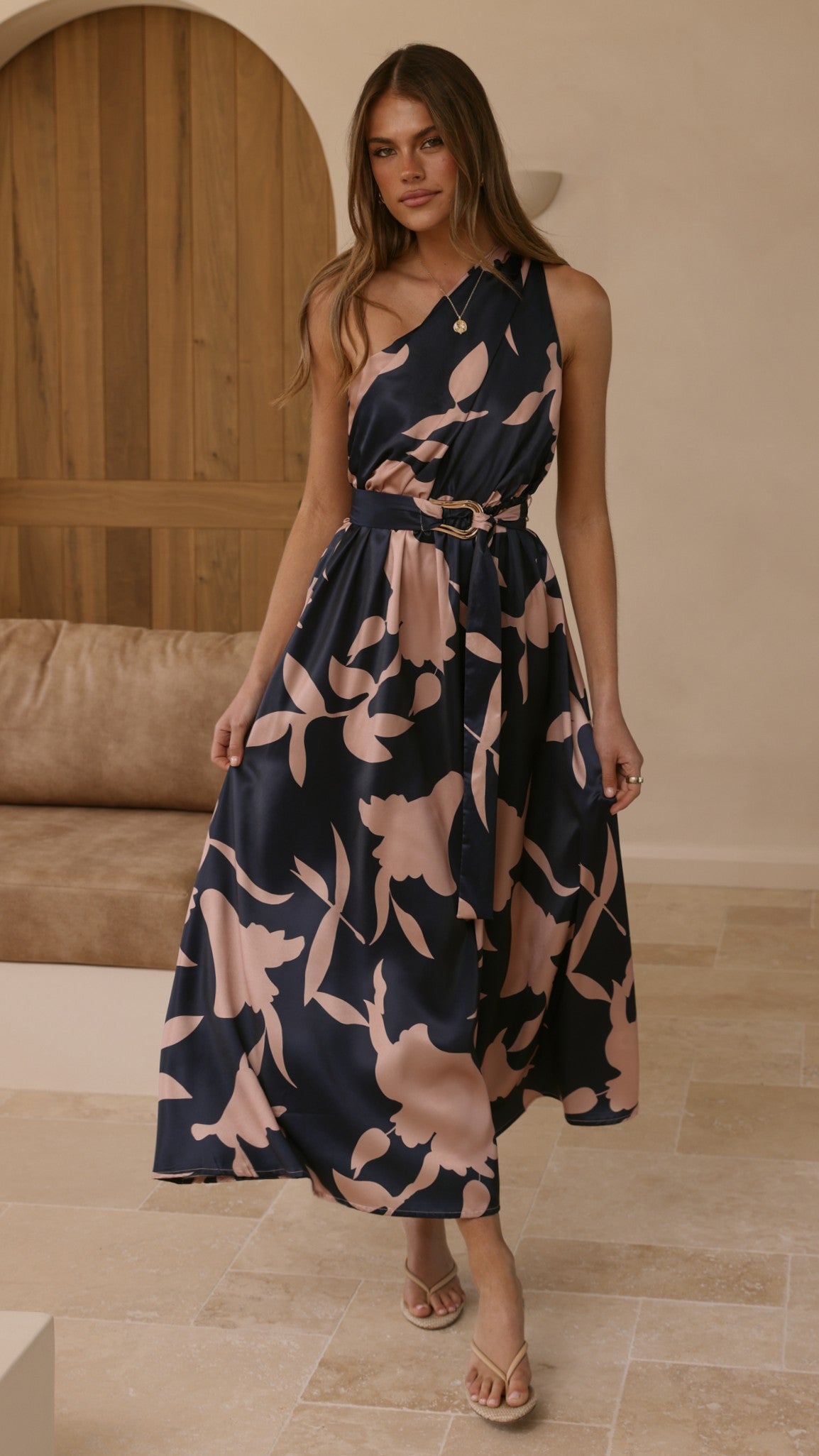 Navy maxi dress with pink floral print, belted waist, sleeveless V-neck.