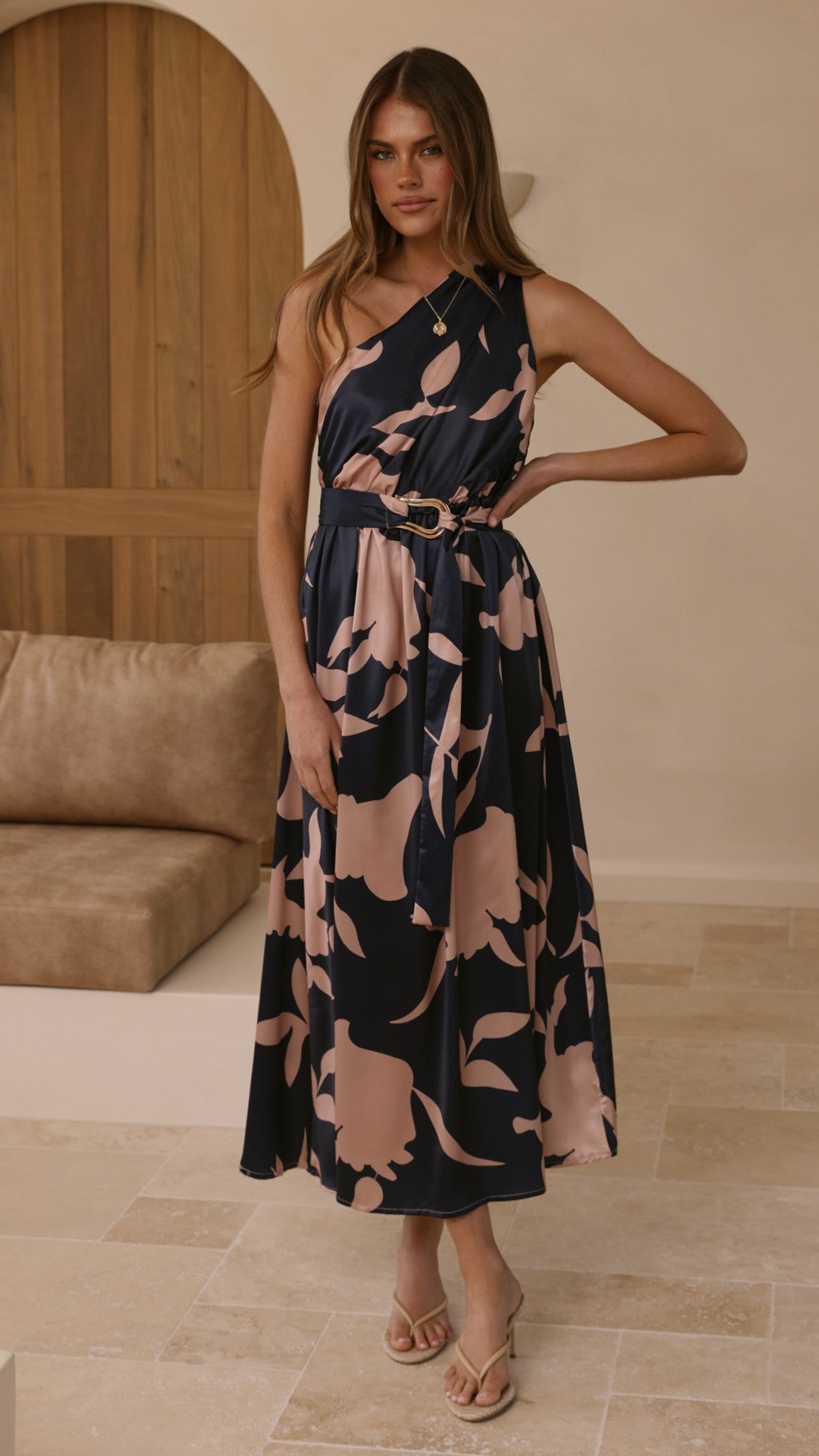 Navy maxi dress with pink floral print, belted waist detail, halter-style neckline.