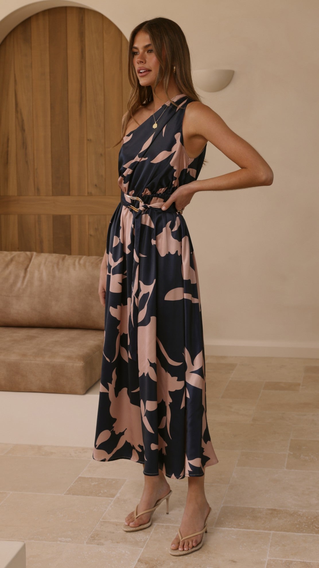 Navy sleeveless maxi dress with pink floral print, fitted waist belt, V-neck.