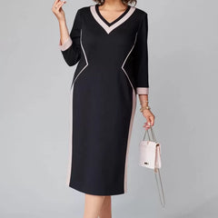 Black knee-length V-neck dress with contrast white trim and long side panel detail