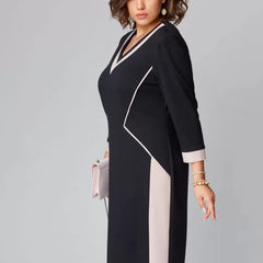 Black V-neck sheath dress with white contrast panels and 3/4 sleeves, midi length