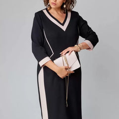 Black V-neck midi dress with contrast white trim along seams, 3/4 sleeves