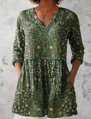 Green long-sleeve V-neck blouse with floral print and tiered waist