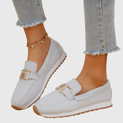 White orthopedic loafer sneakers with gold buckle ornament and low-profile tread