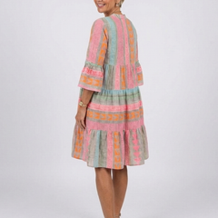 Geometric print tiered knee-length dress with multicolor panels, shown from side/back