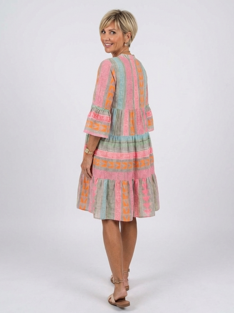 Geometric print tiered knee-length dress with multicolor panels, shown from side/back